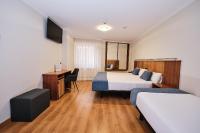 A bed or beds in a room at Hotel Ciudad de Compostela