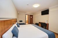 A bed or beds in a room at Hotel Ciudad de Compostela