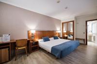 A bed or beds in a room at Hotel Ciudad de Compostela