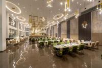 a dining room with tables and chairs and chandeliers at The HEALTHY Stay-Padel, Pool&Fitness in Ayia Napa