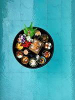 a black plate of food on a blue table at Chalong Marina Bay View Phuket in Rawai Beach