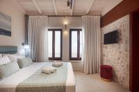 Posteľ alebo postele v izbe v ubytovaní Philikon Luxury Suites