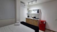 a small room with a bed and a red refrigerator at Flat Casa Mauá in Rio de Janeiro