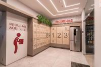 a lobby with a sign on the wall and a sign for a toilet at Flat Casa Mauá in Rio de Janeiro