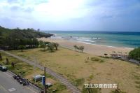 a view of a beach with motorcycles parked on the sand at Ibizakenting Hotel in Kenting