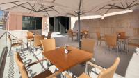 a patio with tables and chairs and an umbrella at Clarion Congress Hotel Olomouc in Olomouc