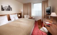 a hotel room with a large bed and a television at Clarion Congress Hotel Olomouc in Olomouc