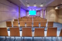 an empty lecture hall with chairs and a screen at Clarion Congress Hotel Olomouc in Olomouc