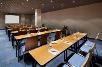 a conference room with wooden tables and chairs at Clarion Congress Hotel Olomouc in Olomouc