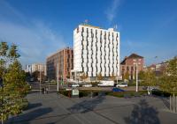 a large white building in a city with buildings at Clarion Congress Hotel Olomouc in Olomouc