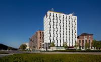 a tall white building on a city street at Clarion Congress Hotel Olomouc in Olomouc