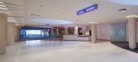 an empty lobby of a building with a sign on the ceiling at Clarion Congress Hotel Olomouc in Olomouc