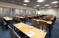 a conference room with wooden tables and chairs at Clarion Congress Hotel Olomouc in Olomouc