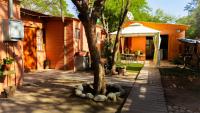 a tree in a yard next to a house at Hostal Perita in San Pedro de Atacama