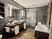 a bathroom with two sinks and a shower and a tub at Villa Spalletti Trivelli - Small Luxury Hotels of the World in Rome