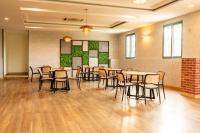 a large room with tables and chairs in it at Casa Hotel, Jubilee Hills in Hyderabad