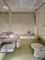 a bathroom with a sink and a toilet and a tub at Hotel Montecarlo in Venice