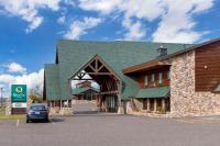 a car parked in front of a building with a green roof at Quality Inn Ashland - Lake Superior in Ashland