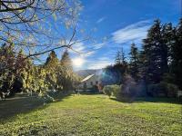 a house in a yard with the sun in the sky at Glamping at Camping La Source in Saint-Pierre-dʼArgençon