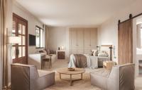 a bedroom with a bed and a table and chairs at Can Jaume by Ocean Drive in Ibiza Town