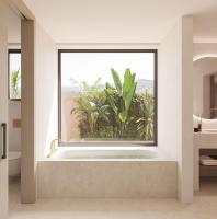 a bathroom with a bath tub with a large window at Can Jaume by Ocean Drive in Ibiza Town
