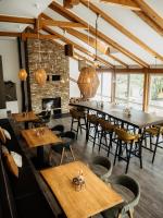 a dining room with tables and chairs and a fireplace at Botanico Finkenrech Hotel&Restaurant in Eppelborn