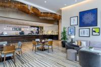 a restaurant with a table and chairs and a bar at Marriott Hotel Downtown Abu Dhabi in Abu Dhabi