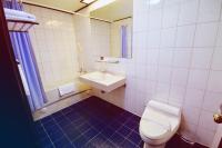 a bathroom with a white toilet and a sink at Abbo Hotel in Tainan