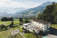 an aerial view of a house with mountains in the background at Hotel Sonnenberg in Luzern