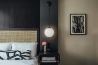 a bedroom with a bed and a lamp on a side table at Hotel Renew in Honolulu