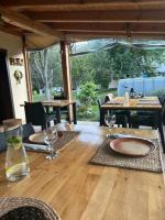 a wooden table with plates and wine glasses on it at Apartments Celopek in Ličko Petrovo Selo
