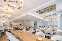 a dining room with tables and white chairs at NARADA Resort Shanghai Hotel Disney Store in Zhuqiao