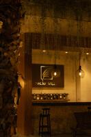 a bar with a sign on a wall with lights at Palm Villa in Nha Trang