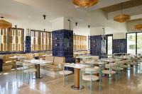 a restaurant with tables and chairs in a room at Ace Hotel & Swim Club Athens in Athens