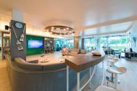 a living room with a clock on the wall at Katathani Phuket Beach Resort - SHA Extra Plus in Kata Beach