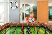 a young boy looking at a pool with toy figures at Katathani Phuket Beach Resort - SHA Extra Plus in Kata Beach