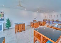 uma sala de jantar com mesas e cadeiras e estofados de aasteryasteryasteryasteryasterestostery em Ice Mist Pool Resort Munnar By VOYE HOMES em Munnar