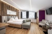 Łóżko lub łóżka w pokoju w obiekcie Austria Alpinhotel Ski IN Ski OUT an der Edelweissbahn