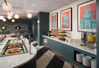 a buffet in a restaurant with food on a counter at Sonesta Los Angeles Airport LAX in Los Angeles