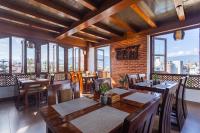 a restaurant with tables and chairs and windows at Timber House by Tara Group in Kathmandu
