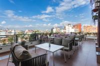 a balcony with tables and chairs and a view of a city at Timber House by Tara Group in Kathmandu