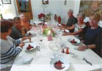 a group of people sitting around a table with food at Chez Providence Chambres et Table d'Hôtes in Cuxac-Cabardès