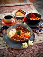 a table with a bowl of food and a plate of food at Izotal Bioluxury Hotel in Taminango