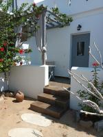 a stairway leading to a house with flowers at Theofanis Studios in Agia Anna Naxos