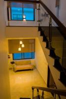 a staircase with a couch in a living room at Hiếu Sang 68 Hostel & Villas Seaview Bến tàu Rạch Giá miễn phí xe đón tiễn 24l24 in Rach Gia