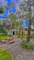 a park with picnic tables and trees and a building at Monteverde Magic Mountain in Monteverde Costa Rica