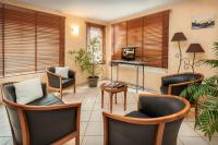 a living room with chairs and a table at BRIT HOTEL Essentiel CAHORS Nord in Cahors