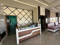 a lobby of a hotel with a reception desk at Alpine Resort in Sivasagar