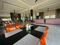 a dining room with a table and chairs at Alpine Resort in Sivasagar