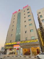 a tall building with a sign in front of it at Al Reem Hotel Apartments in Sharjah